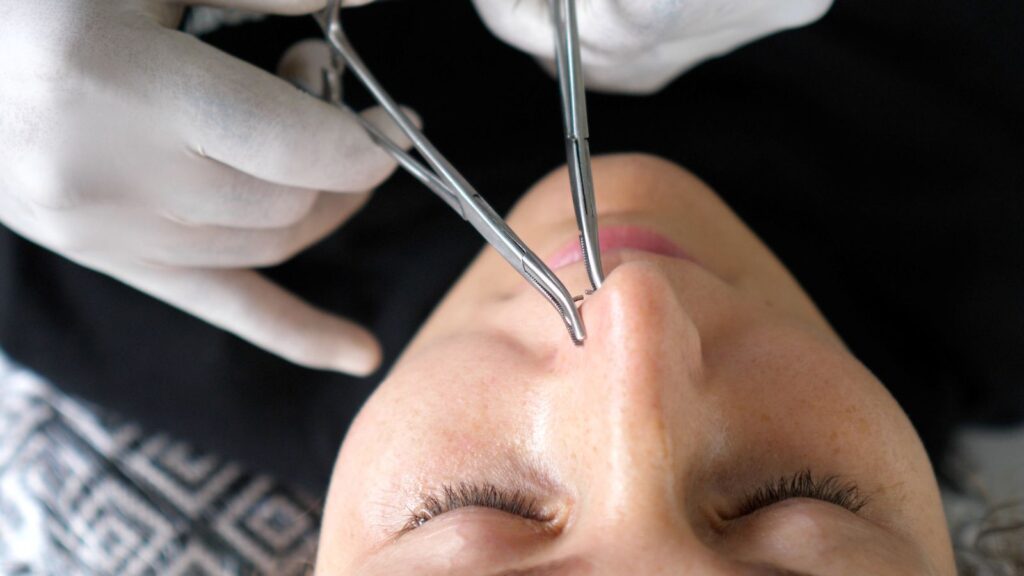 high nostril piercing being performed